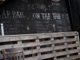 A chalkboard drink menu in a bar 