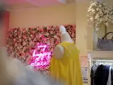 A sign with flowers in a clothing store