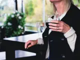 Person holding a glass of wine