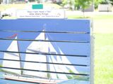 A painting in a park of a sailboat