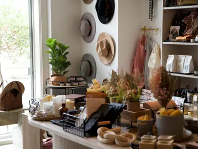 A display table of home decor and hats in a store