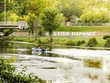 Boat on the water in front of a Greater Napanee sign