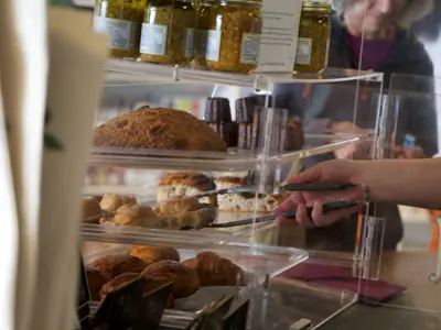 Person picking out a pastry in a bakery